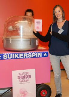 Laura van Eerten, één van de samenstellers, met het boekje 'Waar komt suikerspin vandaan'